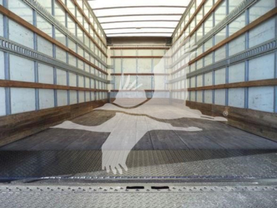 Interior of empty International Durastar 4300 box truck cargo area showing metal walls and floor.