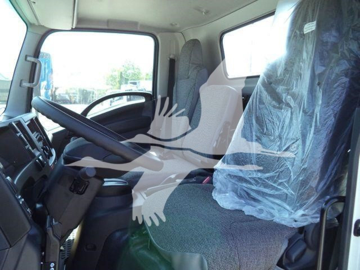 Isuzu NPR-HD truck cab interior showing driver seat and passenger seat wrapped in protective plastic.