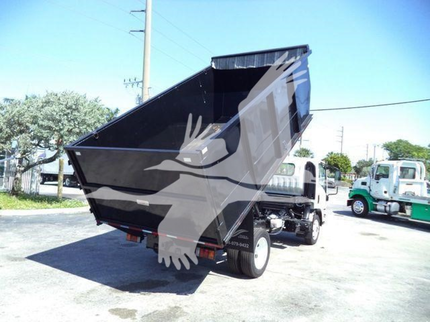 Isuzu NPR-HD dump truck bed in raised position showing rear and side view
