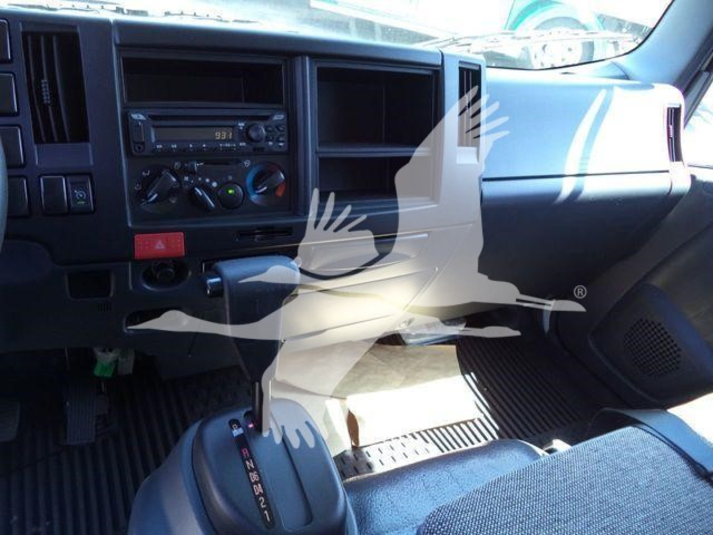 Isuzu NPR-HD truck interior dashboard and center console view with gear selector and climate controls.
