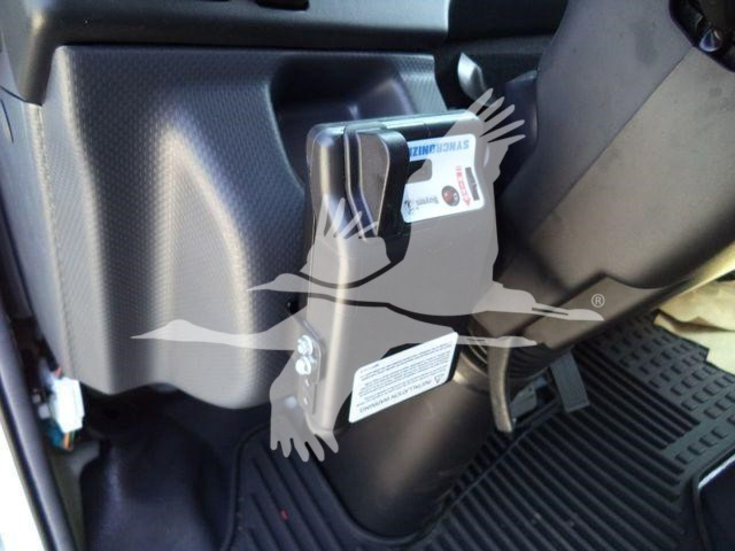Isuzu NPR HD truck interior showing steering column and pedal area with a label close up