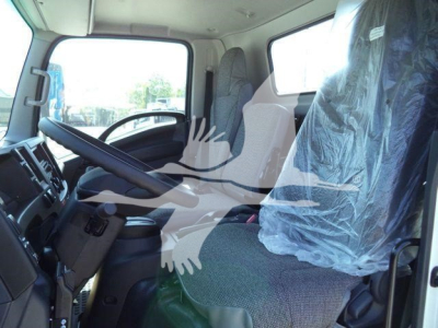 Isuzu NPR-HD truck cab interior showing driver seat and passenger seat wrapped in protective plastic.