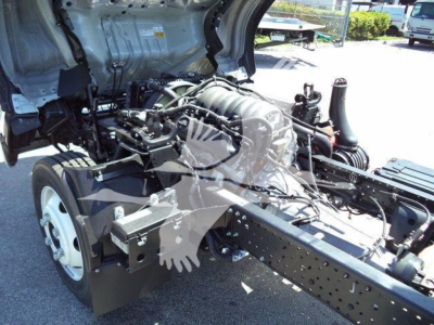 Isuzu NPR-HD truck chassis showing engine and cab wiring area with front wheel and frame rails visible.