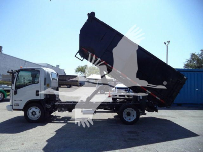 Isuzu NPR-HD dump truck in-service showing cargo bed raised and hydraulic system.