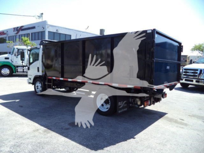 Isuzu NPR-HD dump truck rear/side view showing black dump body with white bird graphic overlay. No legible model text visible.