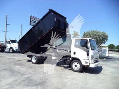 Isuzu NPR-HD truck with raised black dump bed, front cab visible, side view showing tipping mechanism and bed angled upward.