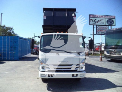 Isuzu NPR-HD truck front view with dump bed raised in dealership lot.