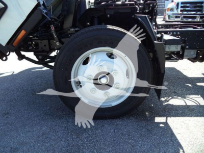 Isuzu NPR-HD truck front wheel and suspension components showing wheel, tire, and chassis.