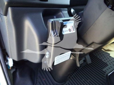 Isuzu NPR HD truck interior showing steering column and pedal area with a label close up