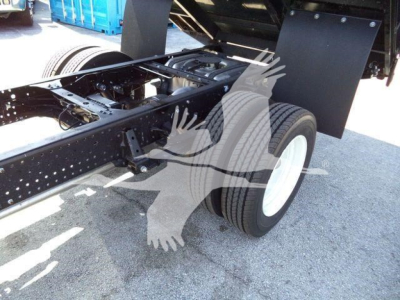 Isuzu NPR-HD truck chassis showing rear wheel and frame with visible metal components and mud flaps.