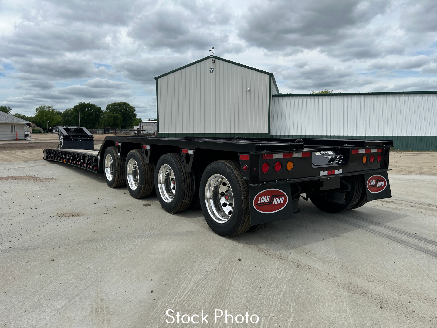 Load King 554 Quad gooseneck trailer with 9' wide loading deck and multiple axles, stock photo showing rear and side view.