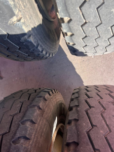 Tires viewed from above with visible treads and sidewalls; no readable branding or serials in frame.