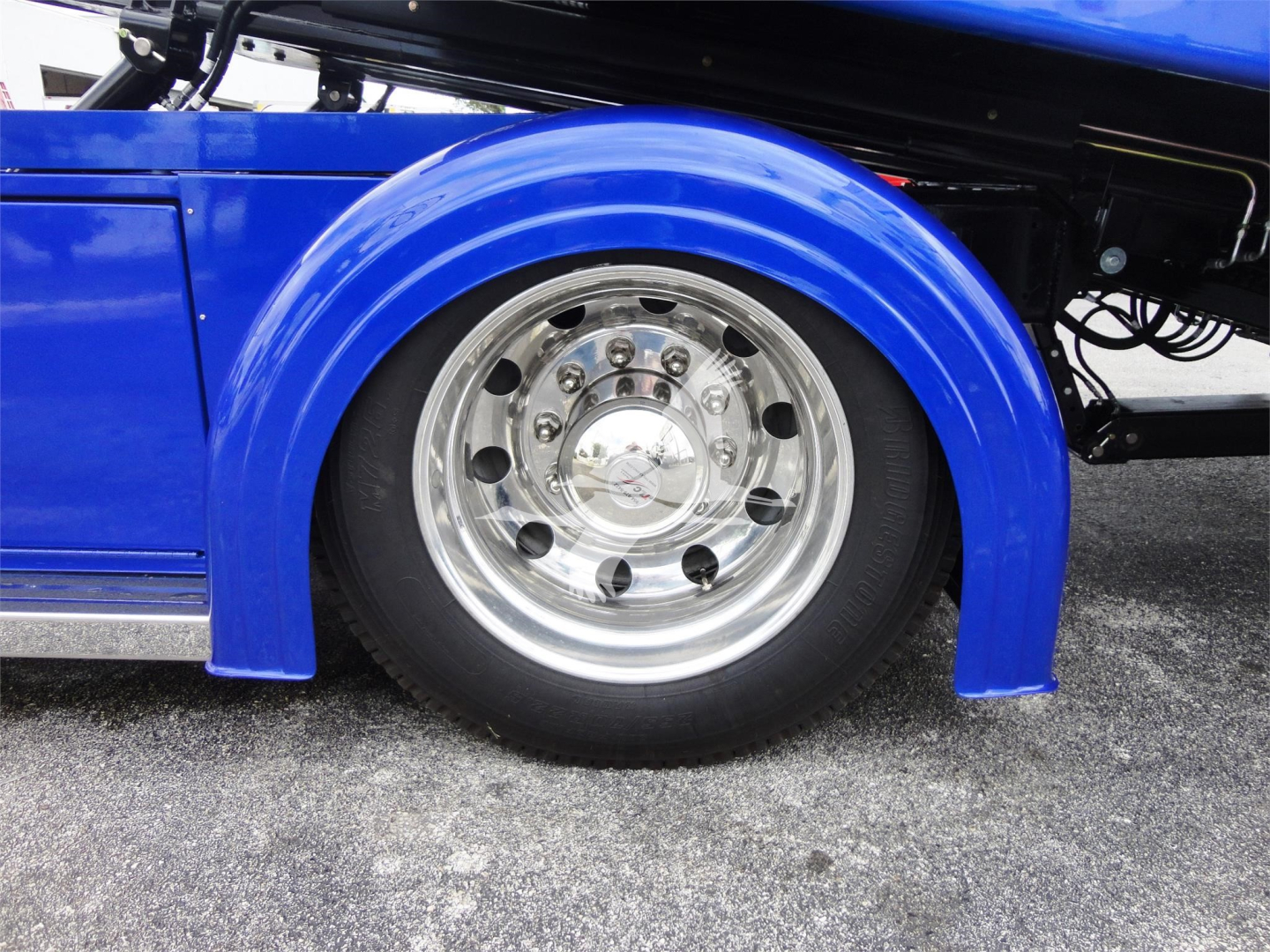 Peterbilt 337 rollback truck wheel and fender with blue paint and polished chrome wheel.