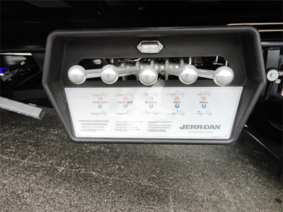 Back view of a 2022 Peterbilt 337 rollback truck showing Jerr-Dan integrated towing controls panel and chrome levers.