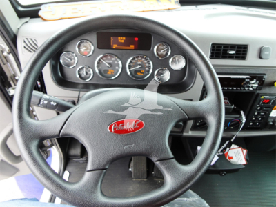 Peterbilt 337 interior view showing steering wheel with Peterbilt emblem and dashboard gauges.