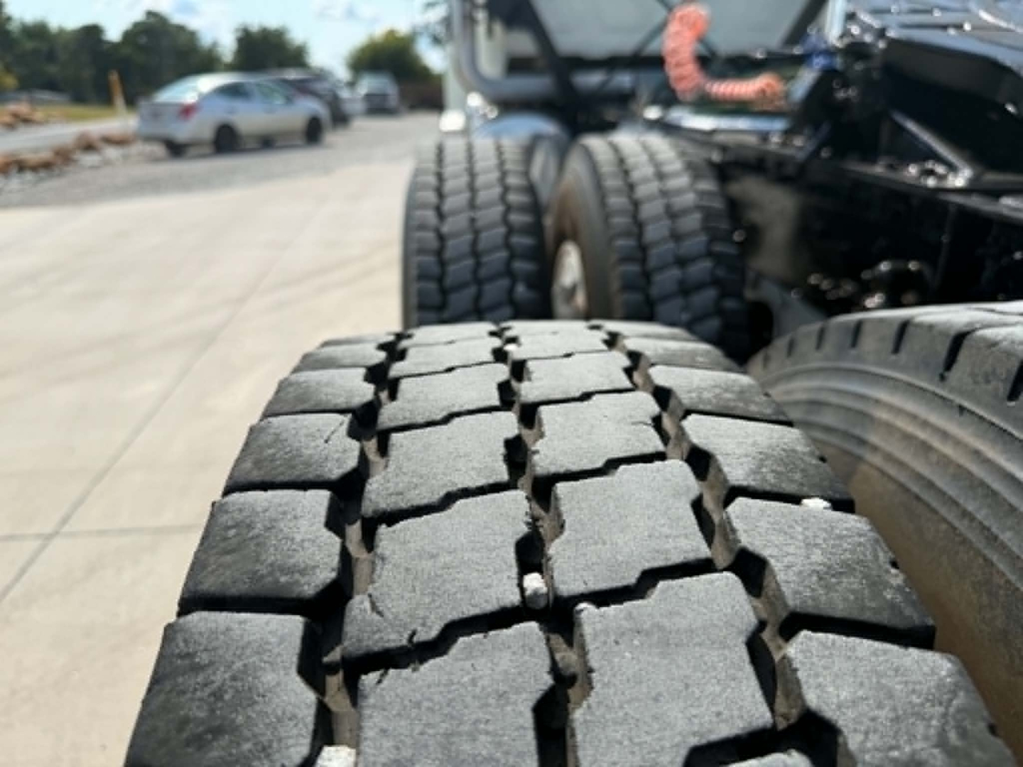 Tire tread close-up on the rear of a 2019 Mack CHU613 truck showing heavy-duty off-road tires.