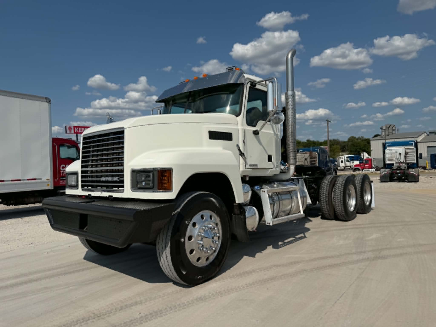 White 2019 Mack CHU613 daycab truck shown from front-left side with large exhaust stack and dual rear axles.