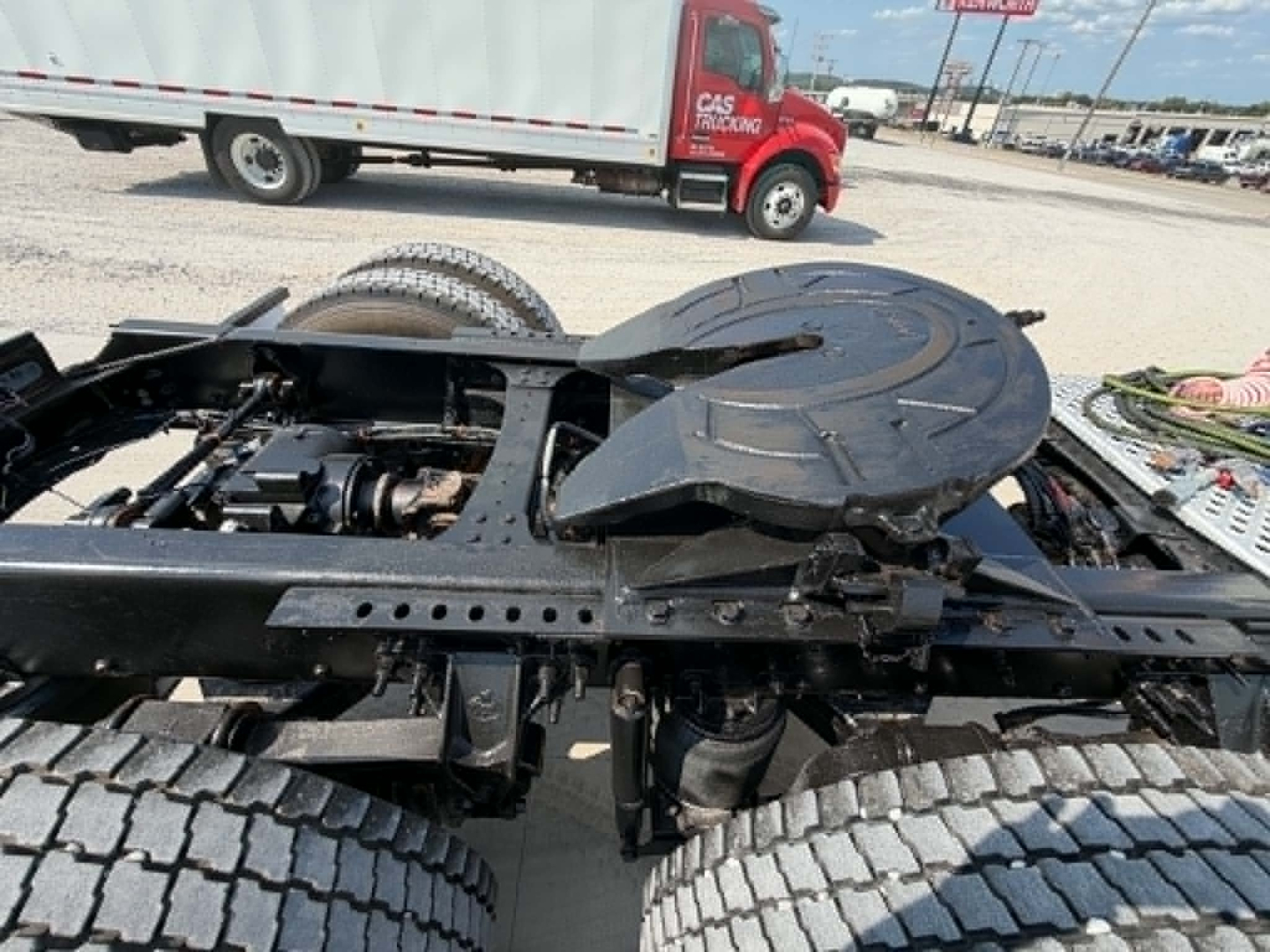 Chassis view of a 2019 Mack CHU613 cab-over truck showing rear frame with dual rear axles and circular spare wheel carrier.