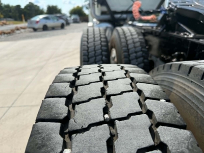 Tire tread close-up on the rear of a 2019 Mack CHU613 truck showing heavy-duty off-road tires.
