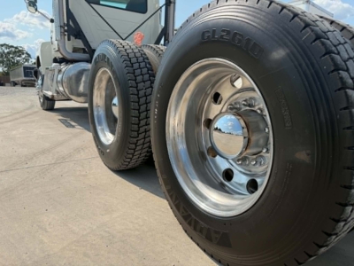 Mack CHU613 truck front wheel close-up showing GL2610 tire and chrome hubcap.