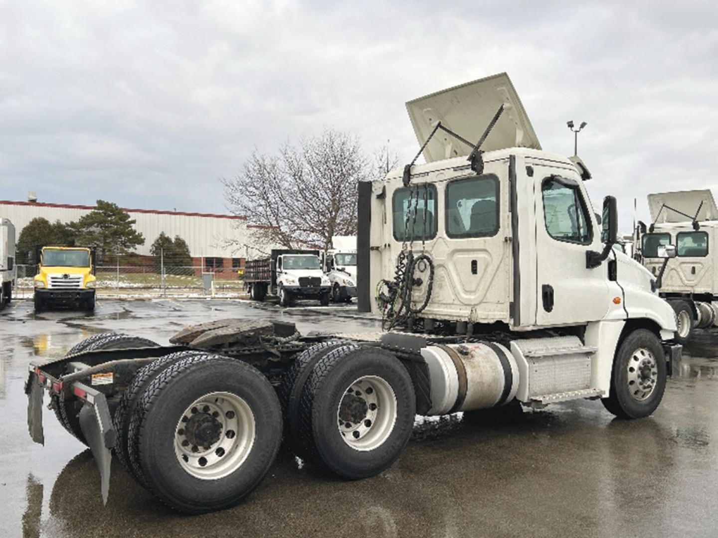 Freightliner Cascadia125 tractor front-quarter view showing rear dual axle and fifth-wheel area.