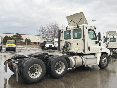 Freightliner Cascadia125 tractor front-quarter view showing rear dual axle and fifth-wheel area.