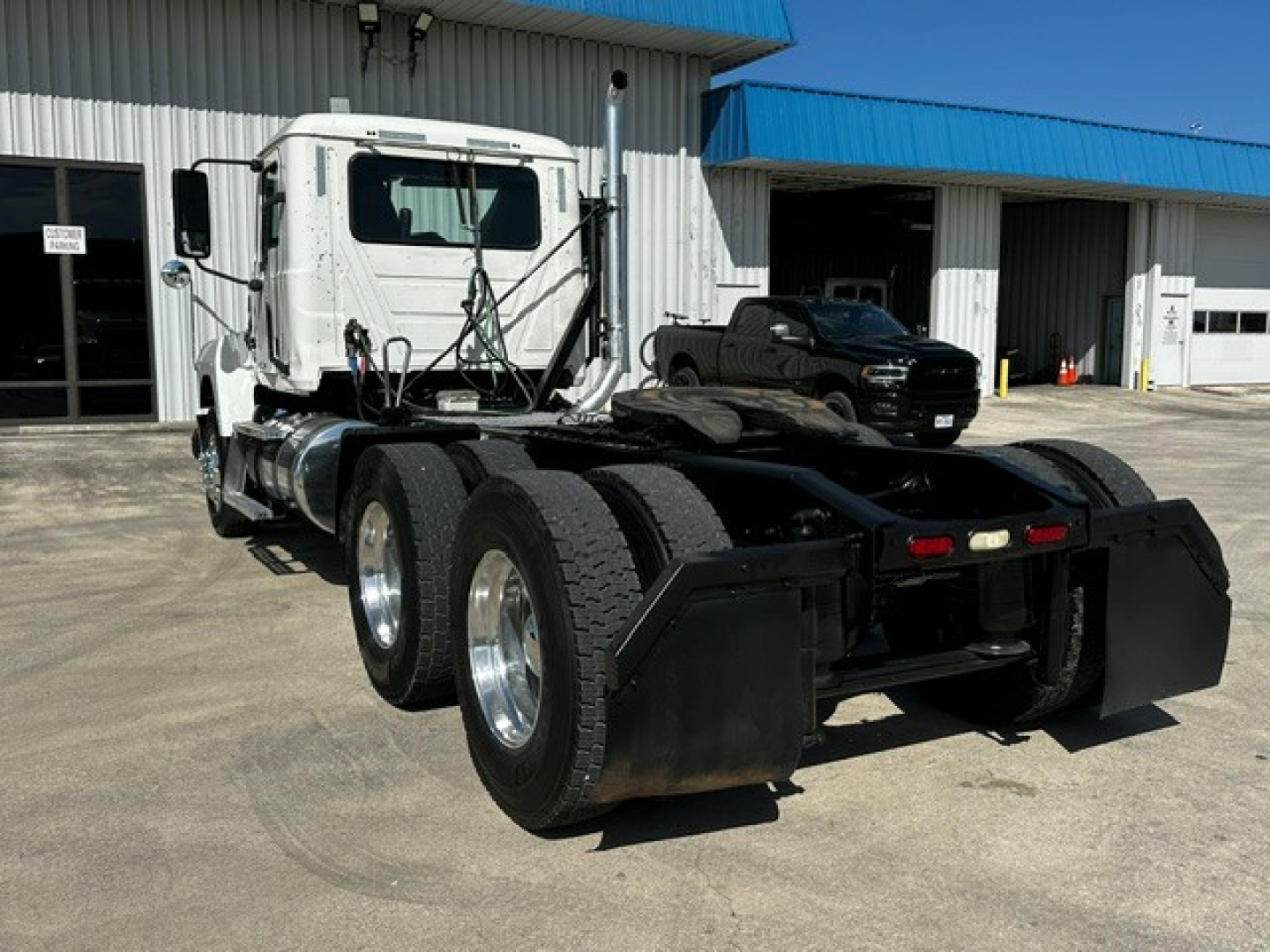 Mack PI64T daycab wheelbase showing rear chassis and dual rear axles with mud flaps and fifth wheel area.
