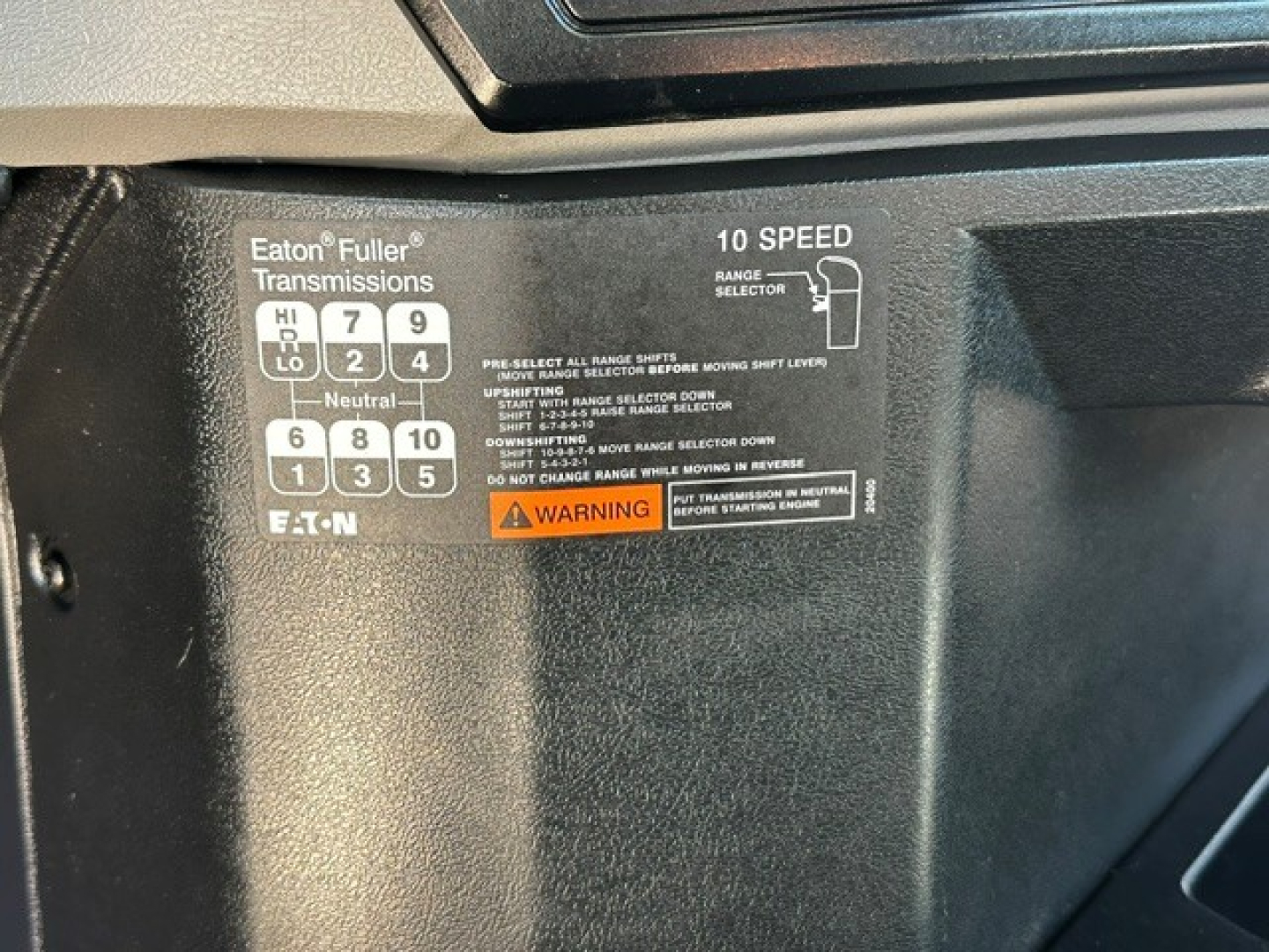 Truck interior label showing Eaton Fuller transmissions shift pattern with 10-speed configuration and warning text visible.