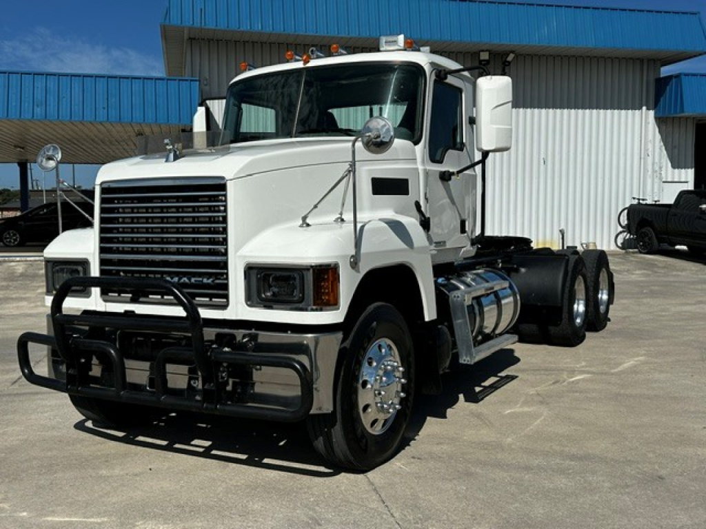 Truck cab exterior of a 2020 Mack PI64T conventional daycab showing front grille, bumper guard, and dual rear wheels.