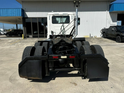 Tractor rear-view showing 2020 Mack PI64T conventional daycab with dual rear axles and mud flaps, fifth wheel missing, white cab, black chassis, stock number W0030.