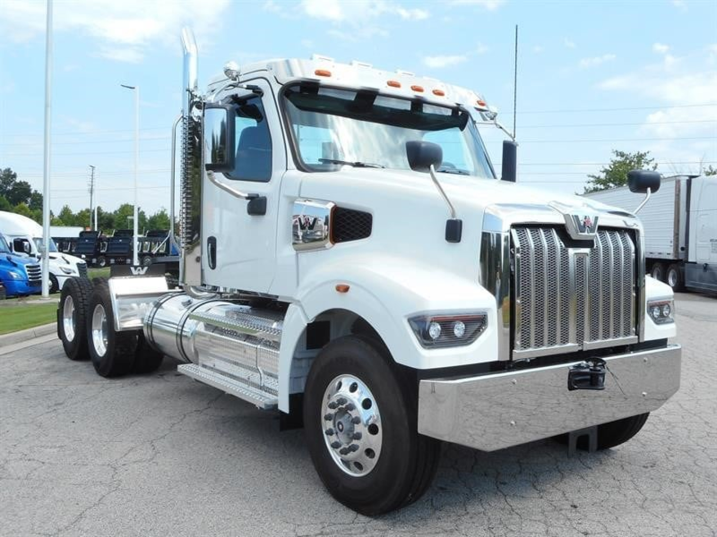 Western Star 49X Day Cab truck in white with chrome grille and heavy-duty bumper, front three-quarter view showing cab and chassis.
