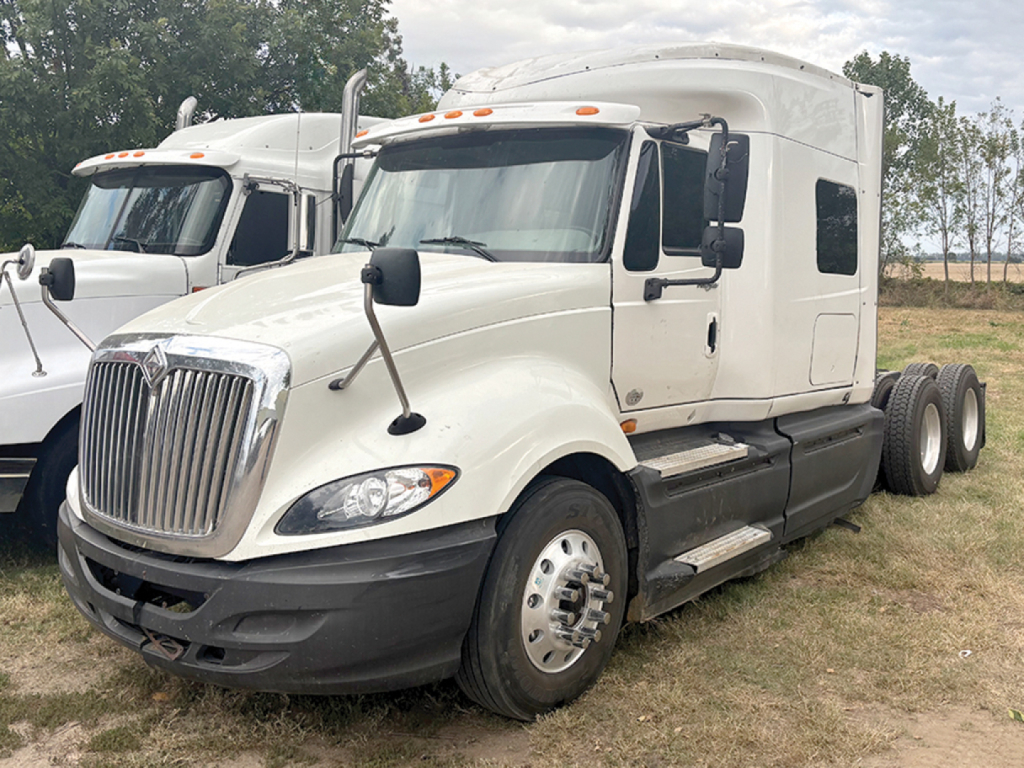 Truck image: 2011 International ProStar sleeper cab with white exterior, dual rear wheels, chrome grille, and black bumper.