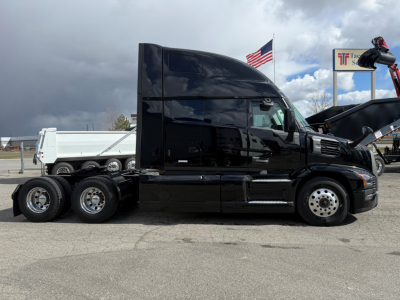 Truck side view showing a black 2026 Mack PR64T76H tractor with sleeper cab and dual rear axles.