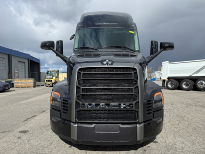 Mack PR64T76H conventional sleeper truck front view showing grille with MACK lettering and large bumper, CV-style headlights and side mirrors.