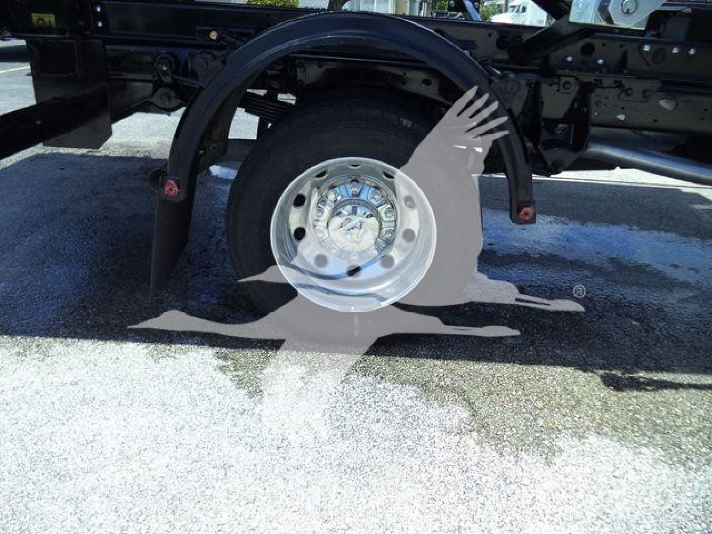 Ram 5500 chassis showing wheel and fender with hitch mount and partial undercarriage components.