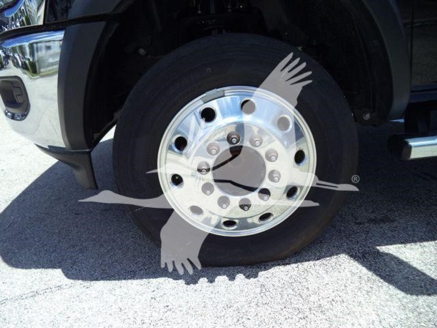 Ram 5500 wheel showing chrome dual rear axle hub and lug nuts with tire and fender visible