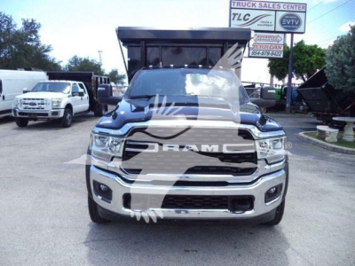 Ram 5500 SLT front view showing bold grille and bumper, in-service vehicle with reflection watermark.