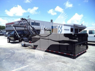 Ram 5500 SLT dump truck with roll-off container in a dealership lot.