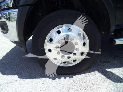 Ram 5500 wheel showing chrome dual rear axle hub and lug nuts with tire and fender visible