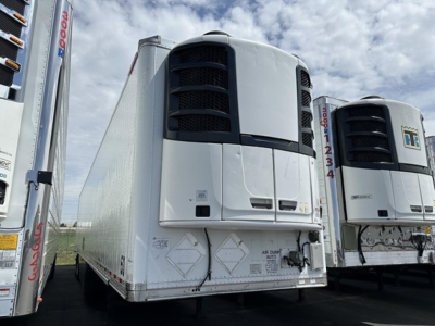 Great Dane S-600 trailer in a line of refrigerated trailers showing front cooling unit area and side panels.