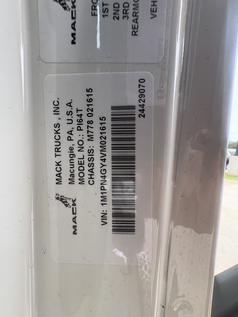 Mack Trucks label with VIN and model information on door jamb; barcode and model/paint details visible.