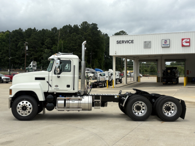 Mack PI64T truck chassis front view showing cab and dual rear axles at service center.
