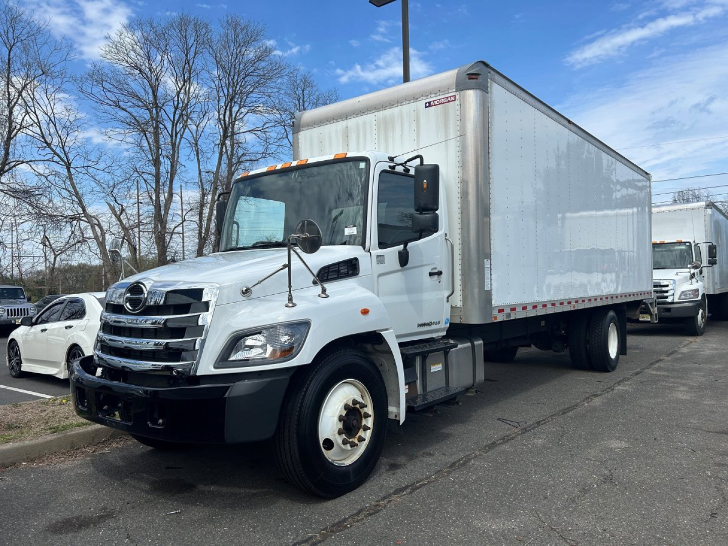 Box van truck showing 2020 Hino 338 with aluminum box rear, front view and cargo area, VIN 5PVNV8JVXL5S60154 visible on listing sheet.