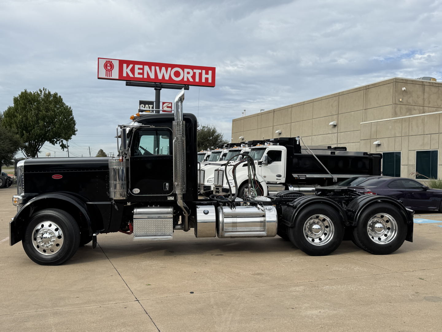 Peterbilt 389 conventional daycab truck side view showing fuel tanks and chrome exhaust stacks.