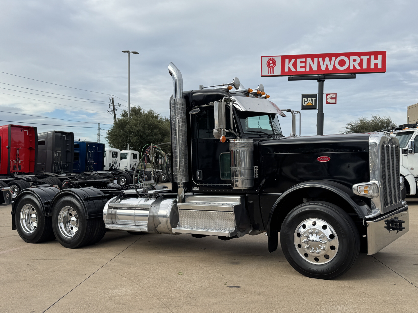 Peterbilt 389 conventional daycab truck in black with chrome fuel tanks and exhaust stack, showing knowledge card in background