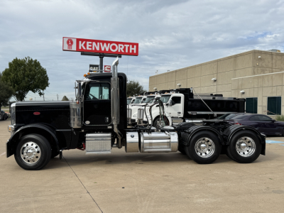 Peterbilt 389 conventional daycab truck side view showing fuel tanks and chrome exhaust stacks.