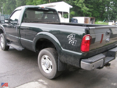 Ford F-250 Super Duty pickup with 4x4 badge in rear quarter showing bed and plow prep area.