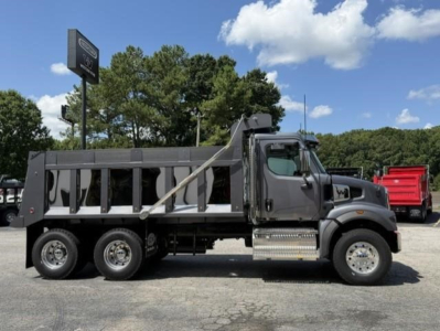 New Western Star 47X dump truck side view showing cab, dump bed, six wheels, chrome steps, and cargo area.