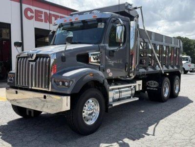 Western Star 47X dump truck in gray with chrome bumper and dual rear axles, viewed from front-left side, stock number 351385.