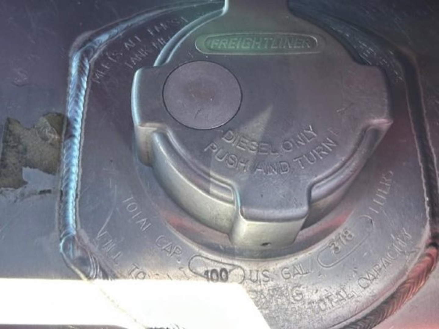Fuel cap area of a Freightliner Cascadia 126 engine bay showing Diesel Only Push and Turn cap